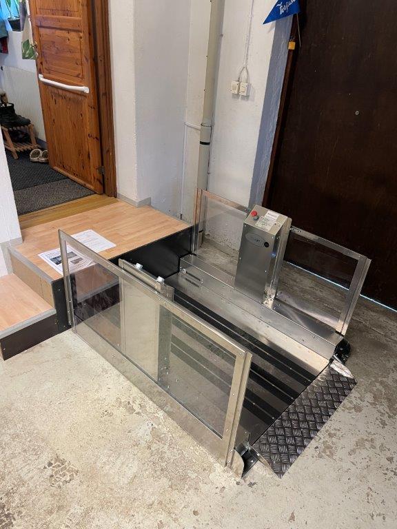 a metal and glass counter in a room.