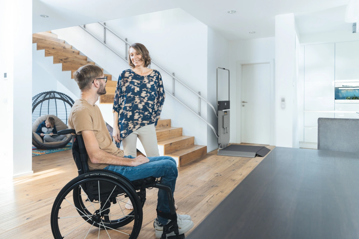 Man in wheelchair with wheelchair lift on stairs