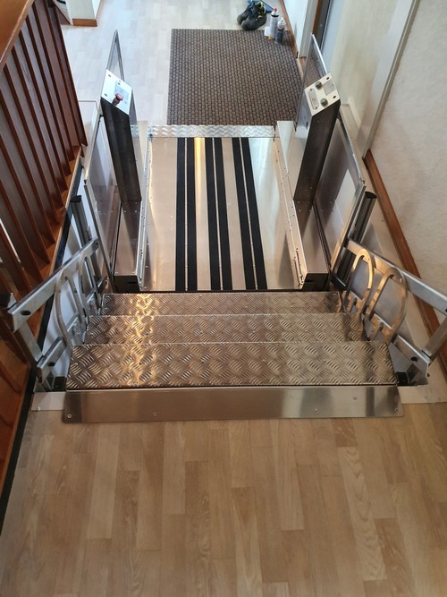 a metal stair case sitting on top of a hard wood floor.