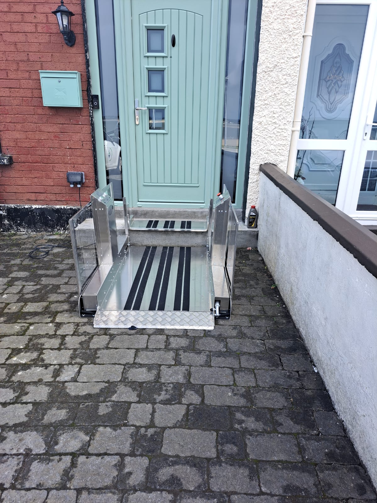 a metal bench sitting in front of a blue door.